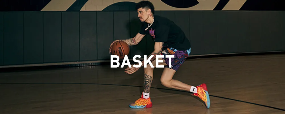 Imagen de un hombre salltando para anotar una canasta de basketball